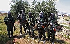 In this Friday, April 12, 2013 photo, members of the Lebanese pro-Syrian Popular Committees pose for a photograph at the Lebanon-Syria border, near the northeastern Lebanese town of al-Qasr, Lebanon. (photo credit:AP/Bilal Hussein)