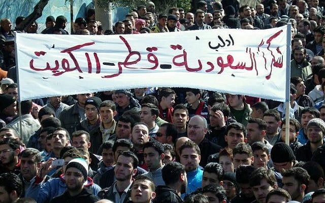Anti-Syrian regime protesters hold up a banner in Arabic reading: "Thank you Saudi Arabia, Qatar and Kuwait," during a demonstration, in Idlib province, northern Syria, in March 2012. (photo credit: AP/Local Coordination Committees in Syria) Anti-Syrian regime protesters hold up a banner in Arabic reading: "Thank you Saudi Arabia, Qatar and Kuwait," during a demonstration, in Idlib province, northern Syria, in March 2012. (photo credit: AP/Local Coordination Committees in Syria)