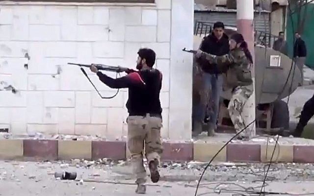 Free Syrian Army fighters fire at Syrian army soldiers during a fierce firefight in Syria, March 18, 2013. (photo credit: AP/Shaam News Network) Free Syrian Army fighters fire at Syrian army soldiers during a fierce firefight in Syria, March 18, 2013. (photo credit: AP/Shaam News Network)