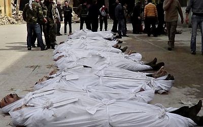 This file citizen journalism image taken on, Sunday, March. 10, 2013 and provided by Aleppo Media Center AMC which has been authenticated based on its contents and other AP reporting, shows Syrians standing next to dead bodies that have been pulled from the river near Aleppo's Bustan al-Qasr neighborhood, Syria (photo credit: AP/AMC)