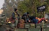 Rebels affiliated with al-Qaeda sit on a truck full of ammunition in northern Syria, January 11, 2013 (photo credit: AP/Edlib News Network ENN)