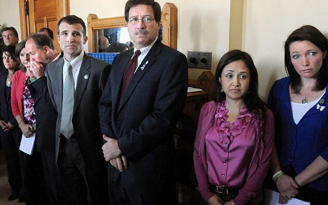 Relatives and supporters of Sandy Hook Elementary School shooting victims stand during a presentation at the Capital in Hartford, Conn., Monday, April 1, 2013, where they asked lawmakers to include a ban on existing high-capacity magazines in a legislation addressing gun control spurred by the massacre (photo credit: AP/New Haven Register, Mara Lavitt) Relatives and supporters of Sandy Hook Elementary School shooting victims stand during a presentation at the Capital in Hartford, Conn., Monday, April 1, 2013, where they asked lawmakers to include a ban on existing high-capacity magazines in a legislation addressing gun control spurred by the massacre (photo credit: AP/New Haven Register, Mara Lavitt)