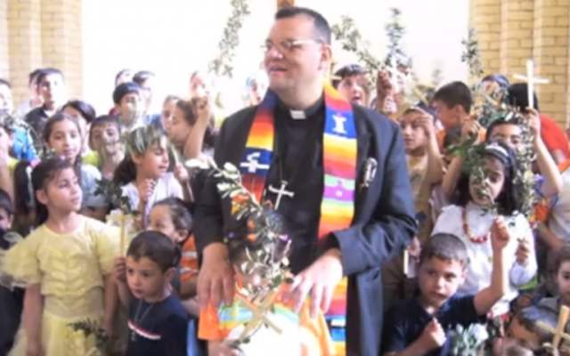 Canon Andrew White at St. George's Church, Baghdad, with children from his congregation (screenshot: YouTube) Canon Andrew White at St. George's Church, Baghdad, with children from his congregation (screenshot: YouTube)