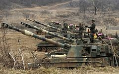 South Korean marines stand on their K-55 self-propelled howitzers during an exercise against possible attacks by North Korea near the border village of Panmunjom in Paju, South Korea on Monday, April 1, 2013 (photo credit: AP/Ahn Young-joon)