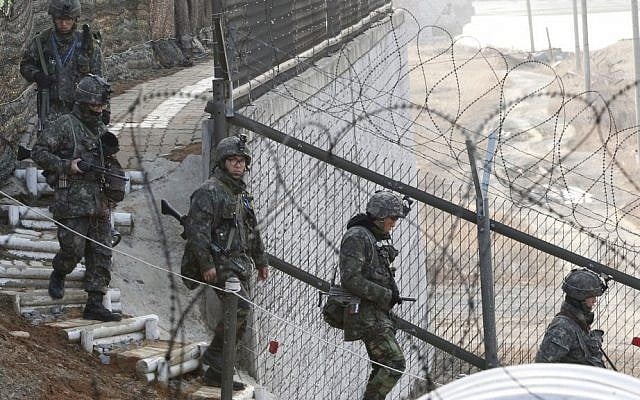 South Korean Army soldiers patrol along a barbed wire fence near the border village of Panmunjom, South Korea on Sunday (photo credit: AP/Ahn Young-joon)