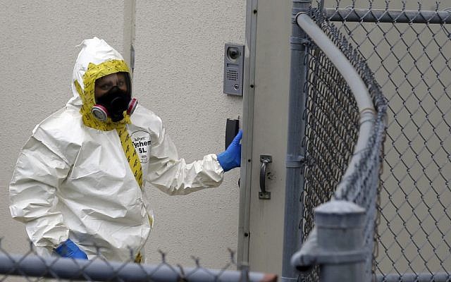 A Prince George's County, Md. firefighter dressed in a protective suit walks into a government mail screening facility in Hyattsville, Md., on Wednesday, (photo credit: AP/Alex Brandon) A Prince George's County, Md. firefighter dressed in a protective suit walks into a government mail screening facility in Hyattsville, Md., on Wednesday, (photo credit: AP/Alex Brandon)