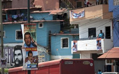 Posters featuring Venezuela's late president Hugo Chavez and interim President Nicolas Maduro hang on a pole at the 23 de Enero neighborhood in Caracas, Venezuela, Friday, April 12, 2013. Maduro,who served as Chavez's foreign minister and vice president, is running against part-Jewish opposition candidate Henrique Capriles in Sunday's presidential election. (AP Photo/Ariana Cubillos)