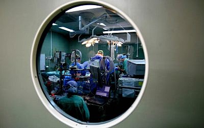 Surgeons and nurses performing surgery in an Israeli hospital on January 15. 2007. (photo credit: Nati Shohat /Flash90)