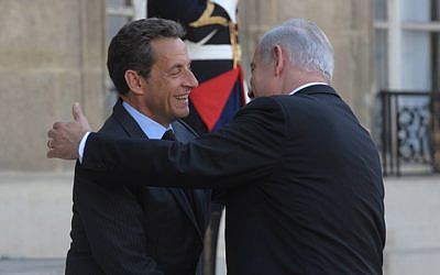 Prime Minister Benjamin Netanyahu embraces then French president Nicholas Sarkozy in Paris, in 2011 (photo credit:  Amos Ben Gershom/GPO)