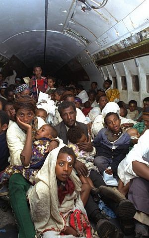 New Ethiopian immigrants on an aircraft en route from Addis Ababa to Israel during Operation Solomon in 1991 (photo credit: Natan Alpert/GPO)