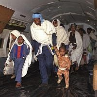 New Ethiopian immigrants boarding an aircraft en route from Addis Ababa to Israel during Operation Solomon, 1991. (Natan Alpert/GPO)