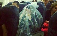 An ultra-Orthodox man is seen encased in plastic on a plane. (photo credit: via Imgur)