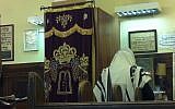 An illustrative photo of a man praying at a synagogue. (photo credit: Aaron Kalman)