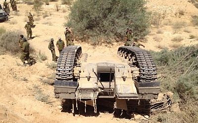 Soldiers examine a tank after it flipped during a training accident, Tuesday (photo credit: Alon Chasid)