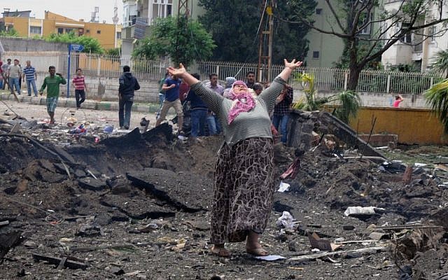 A woman cries at the scene of one of the explosion sites in Reyhanli, near Turkey's border with Syria, on Saturday, May 11, 2013. (photo credit: AP Photo/Anadolu Agency, Cem Genco)