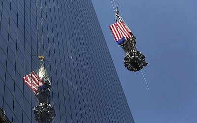 The final piece of the spire is hoisted to the roof of One World Trade Center in New York, Thursday, May 2 (photo credit: AP/Mark Lennihan)