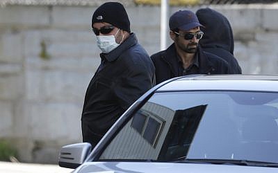 Unidentified men accompany Ruslan Tsarni, not shown, uncle of killed Boston Marathon bombing suspect Tamerlan Tsarnaev, as they depart the Graham, Putnam, and Mahoney Funeral Parlors, in Worcester, Mass., Sunday, May 5 (photo credit: AP/Steven Senne)