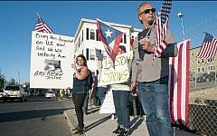 From left, Lisa Taurasi, Lucy Rodriguez and Luis Barbosa, all of Worcester, Mass., hold protest signs as they stand across the street from Graham Putnam & Mahoney Funeral Parlors in Worcester, Mass. on Sunday evening, May 5, 2013. They are upset about the possibility that Boston marathon bombing suspect Tamerlan Tsarnaev may be buried in the United States, and that the body is being held at Graham Putnam & Mahoney Funeral Parlors while a search for a cemetery willing to bury him continues. (photo  credit: AP/Worcester Telegram & Gazette, Betty Jenewin)