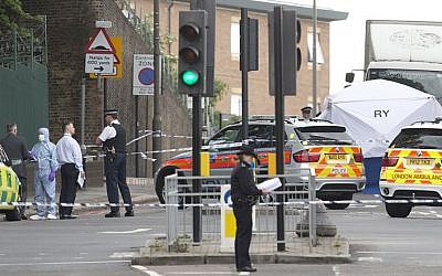 Police and forensic officers near the scene of a terror attack near Woolwich barracks in London, May 22, 2013. (AP/Alastair Grant)