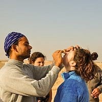 Swadesh Sharma helps Melanie Robbins with an advanced nasal passage kriya using a small tube (photo credit: Michal Shmulovich)