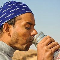 Swadesh Sharma drinks saline water, which he then blows out his nose. The noninvasive technique cleanses the nasal passage. (photo credit: Michal Shmulovich)