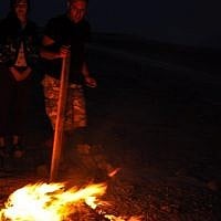 Warming up the evening fire (photo credit: Michal Shmulovich) Warming up the evening fire (photo credit: Michal Shmulovich)