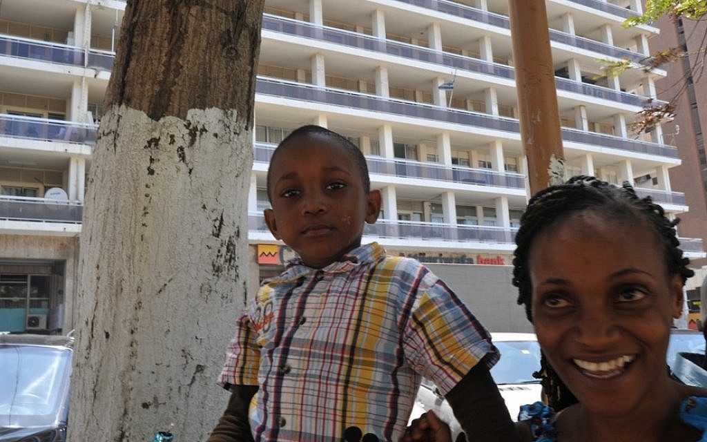 A Senegalese mother and her son standing outside the Israeli Embassy in Dakar, April 2013. (photo credit: Cnaan Liphshiz/JTA) A Senegalese mother and her son standing outside the Israeli Embassy in Dakar, April 2013. (photo credit: Cnaan Liphshiz/JTA)