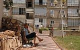 A woman sits outside an underground bomb shelter in Nahariya. (photo credit: Yossi Zamir/Flash90/File)