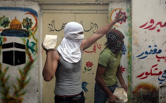 A Palestinian youth prepares to throw a stone at Israeli policemen near Jerusalem's Lion Gate, October 2009 (photo credit: Yossi Zamir/Flash90) A Palestinian youth prepares to throw a stone at Israeli policemen near Jerusalem's Lion Gate, October 2009 (photo credit: Yossi Zamir/Flash90)