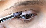 Illustrative photo of a woman applying eyeshadow. (photo credit: Sophie Gordon/Flash90)