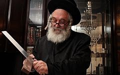 A rabbi sharpens the knife to be used for traditional Jewish slaughter (illustrative photo credit: Kobi Gideon/Flash90)