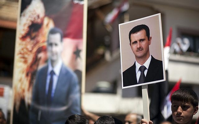 Druze residents of the Golan Heights hold aloft Syrian flags and portraits of Syria's President Bashar Assad, during a rally in the Druze village of Majdal Shams, to mark the Syrian Independance Day, April 17, 2012 (photo credit: Matanya Tausig/Flash90) Druze residents of the Golan Heights hold aloft Syrian flags and portraits of Syria's President Bashar Assad, during a rally in the Druze village of Majdal Shams, to mark the Syrian Independance Day, April 17, 2012 (photo credit: Matanya Tausig/Flash90)
