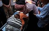 The son of Jewish settler Evyatar Borovsky, a 31-year old father of five, who was killed in a terror attack lies on his father's body during his funeral in the northern Israeli town of Kfar Hasidim. (photo credit: Avishag Shaar Yashuv/Flash90)