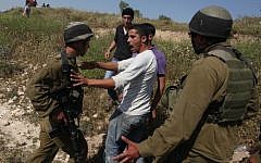 Israeli Border Police argue with Palestinians during clashes between Jewish settlers and Palestinians from the West Bank, near Nablus, April 30, 2013 (photo credit: Issam Rimawi/Flash90)