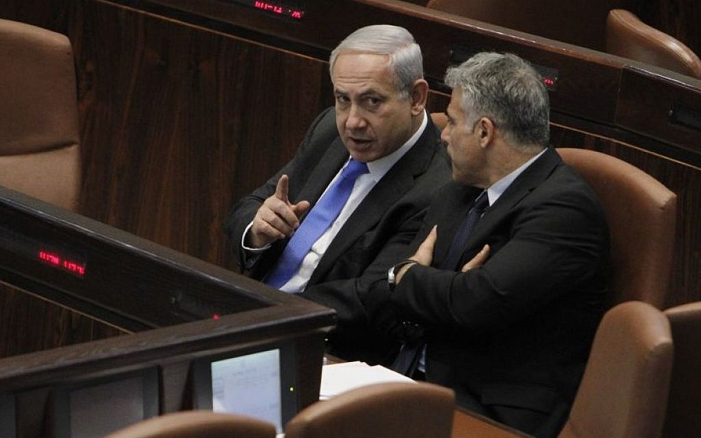 Finance Minister Yair Lapid speaking with Prime Minister Benjamin Netanyahu in the Knesset, May 1, 2013. (Photo credit: Miriam Alster/FLASH90)