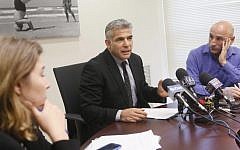 Finance Minister Yair Lapid leads a Yesh Atid party meeting in the Knesset. (photo credit: Miriam Alster/Flash90)