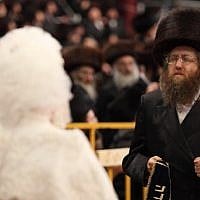 The bride,  Hana Batya Pener, is entreated to a "mitzvah tantz" at her wedding to Rabbi Shalom Rokach, the grandson of the Belz Rabbi, on Tuesday. The dance is a highlight of the wedding ceremony, in which the bride holds one end of a sash while her father and other important men in the community dance on the other end. (Photo credit: Yaakov Naumi/Flash90)