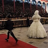 The bride,  Hana Batya Pener, is entreated to a "mitzvah tantz" at her wedding to Rabbi Shalom Rokach, the grandson of the Belz Rabbi, on Tuesday. The dance is a highlight of the wedding ceremony, in which the bride holds one end of a sash while her father and other important men in the community dance on the other end. (Photo credit: Yaakov Naumi/Flash90)