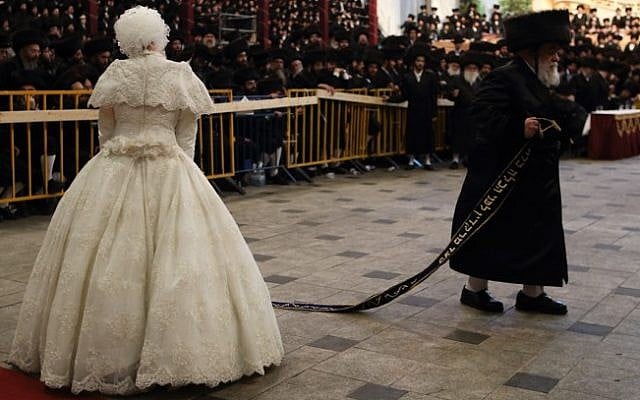 The bride, Hana Batya Pener, is entreated to a "mitzvah tantz" at her wedding to Rabbi Shalom Rokach, the grandson of the Belz Rabbi, on Tuesday. The dance is a highlight of the wedding ceremony, in which the bride holds one end of a sash while her father and other important men in the community dance on the other end. (Photo credit: Yaakov Naumi/Flash90) The bride, Hana Batya Pener, is entreated to a "mitzvah tantz" at her wedding to Rabbi Shalom Rokach, the grandson of the Belz Rabbi, on Tuesday. The dance is a highlight of the wedding ceremony, in which the bride holds one end of a sash while her father and other important men in the community dance on the other end. (Photo credit: Yaakov Naumi/Flash90)