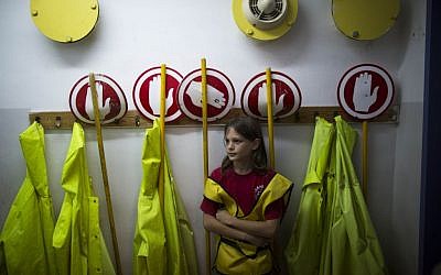 A schoolgirl waits in a shelter on Monday as an air raid siren sounds during an IDF Home Front Command drill simulating a bombing attack (photo credit: Yonatan Sindel/Flash90)