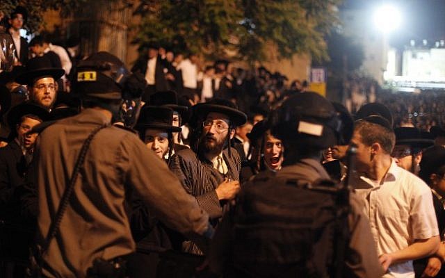Israeli police officers confront ultra-Orthodox demonstrators during a protest in front of the army recruitment office in Jerusalem, May 16, 2013. (photo credit: Flash90) Israeli police officers confront ultra-Orthodox demonstrators during a protest in front of the army recruitment office in Jerusalem, May 16, 2013. (photo credit: Flash90)