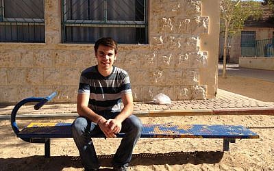 Alexander Gould, who played Shane Botwin in "Weeds," sitting in the playground of the Yeruham elementary school where he taught English this spring (photo credit: Jessica Steinberg/Times of Israel)