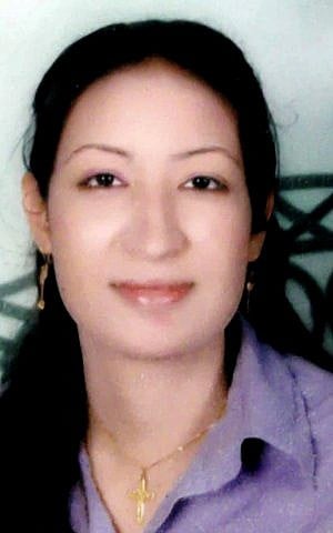 This undated photo provided by the lawyer of Dimyana Abdel-Nour, shows Abdel-Nour, 24, a Coptic Christian teacher in the southern Egyptian city of Luxor in a family photo. Abdel-Nour, went from classroom to jail after lawyers and parents of three students filed a lawsuit accusing the teacher of insulting Islam. (photo credit: AP) 