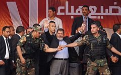 Mohammed Morsi waves to supporters after giving a speech at Tahrir Square in Cairo, on June 29, 2012. (photo credit: AP Photo/Khalil Hamra, File)
