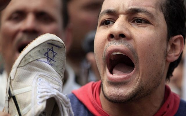 An Egyptian man chants anti-Israeli slogans during a Muslim Brotherhood-staged anti-Israel rally in Cairo, May 11 (photo credit: Khalil Hamra/AP) An Egyptian man chants anti-Israeli slogans during a Muslim Brotherhood-staged anti-Israel rally in Cairo, May 11 (photo credit: Khalil Hamra/AP)