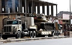 An Egyptian Army vehicle with a tank heads to the closed Rafah border crossing between Egypt and the Gaza strip, in Sheikh Zuweyid, northern Sinai, Egypt, Monday, May 20, 2013 (AP Photo/Roger Anis, El Shorouk Newspaper)