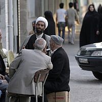 An Iranian clergyman talks with men in the eastern city of Birjand, Iran. (photo credit: AP/Vahid Salemi)