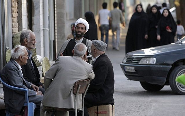 An Iranian clergyman talks with men in the eastern city of Birjand, Iran. (photo credit: AP/Vahid Salemi) An Iranian clergyman talks with men in the eastern city of Birjand, Iran. (photo credit: AP/Vahid Salemi)