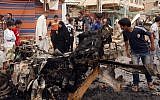 Civilians inspect the scene of a car bomb attack in the Kamaliyah neighborhood, a predominantly Shiite area of eastern Baghdad, Iraq, Monday, May 20, 2013 (photo credit: AP/Hadi Mizban)