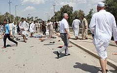 Iraqis gather at the scene of a bomb attack in Baqouba, northeast of Baghdad, Iraq, Friday, May 17 (photo credit: AP/Adem Hadei)